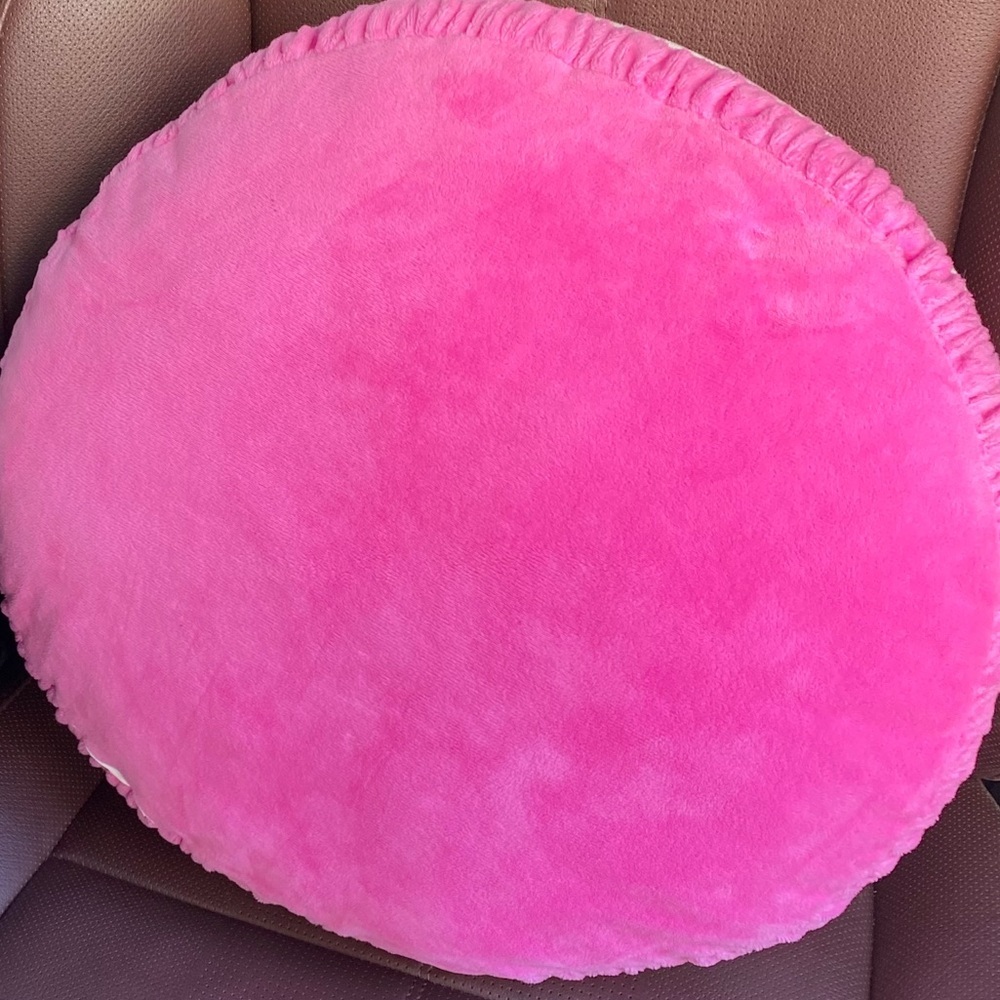 Pink micro fleece plush pink and‎ white round accent pillow.